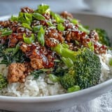 In this easy weeknight dinner, ground turkey is simmered in a sweet-spicy sauce with ginger and garlic, served over nutty brown rice and bright steamed broccoli.