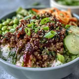 Colorful Korean Ground Beef Bowl with gochujang beef, crunchy carrots, cucumber, and tangy kimchi.