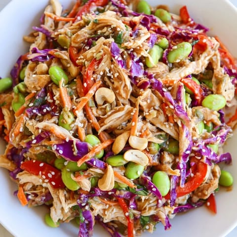 Hearty Edamame Crunch Chicken Salad features colorful veggies, cashews, and a zesty ginger-lime dressing for a refreshing lunch. 