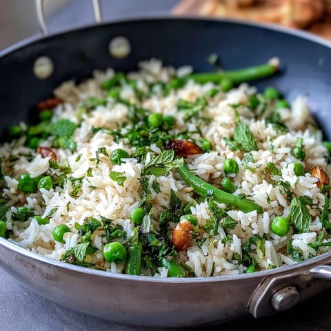 Spring Pea and Mint Rice Pilaf with vibrant green peas and fresh mint, a fragrant vegetarian side dish for spring meals.