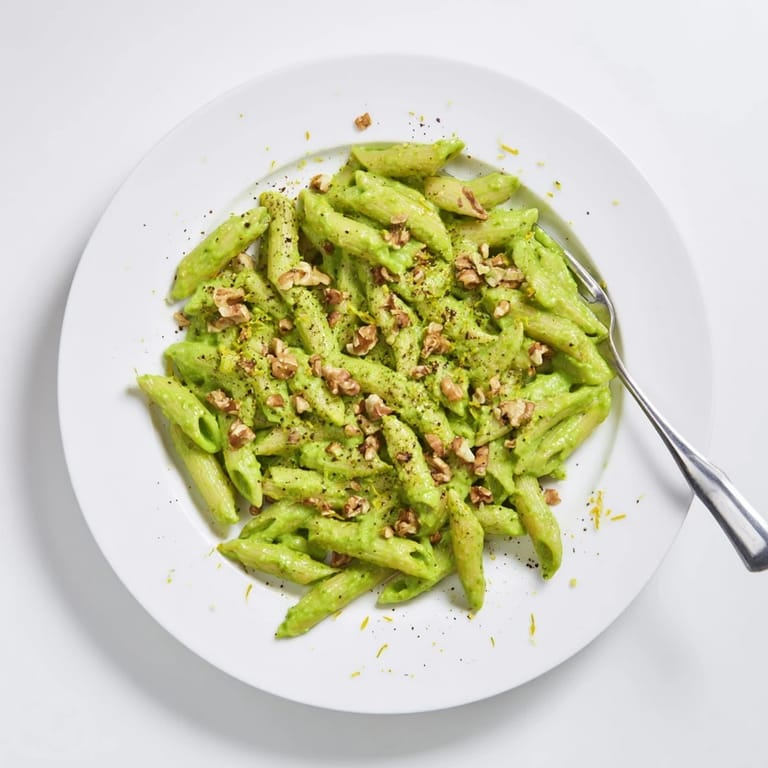 Vibrant green sauce clings to each bite of Creamy Spinach Walnut Pasta, making it a perfect easy weeknight dinner.