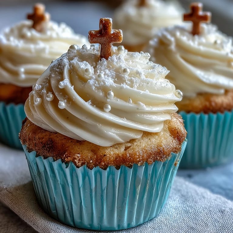 Delicious vanilla Communion cupcakes finished beautifully with fluffy frosting and a simple cross topper.