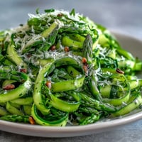 Fresh asparagus ribbons tossed with lemon and Parmesan, a bright spring salad with a zesty citrus dressing.  